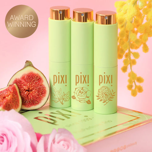Award Winning: PixiPerfume Gift Trio shown on a pink background with plants - view 2 view 1