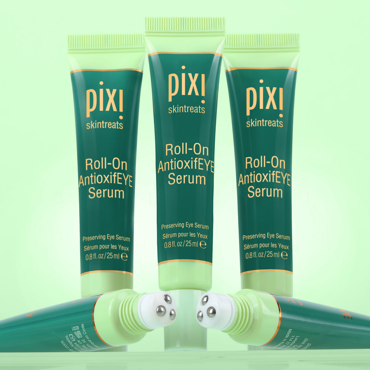 Three tubes of pixi Roll-On AntioxifEYE Eye Serum on a light green background
